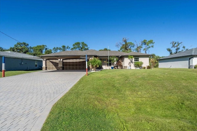 single story home featuring a carport, a garage, and a front yard