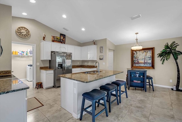 kitchen featuring stainless steel appliances, lofted ceiling, white cabinets, and sink