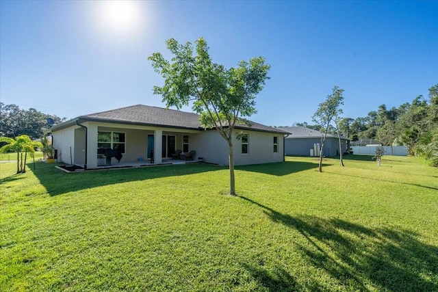 rear view of house with a yard