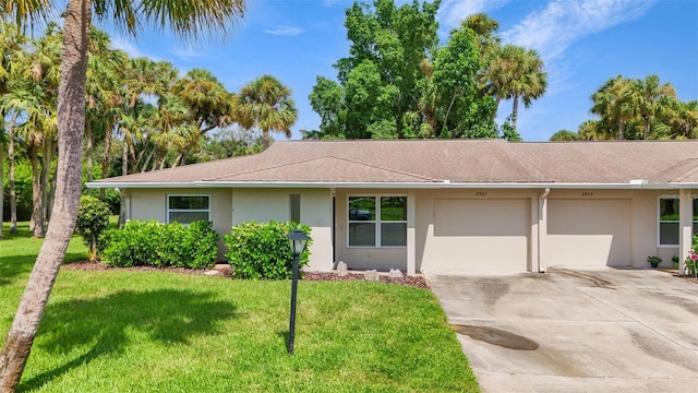 single story home featuring a garage and a front yard