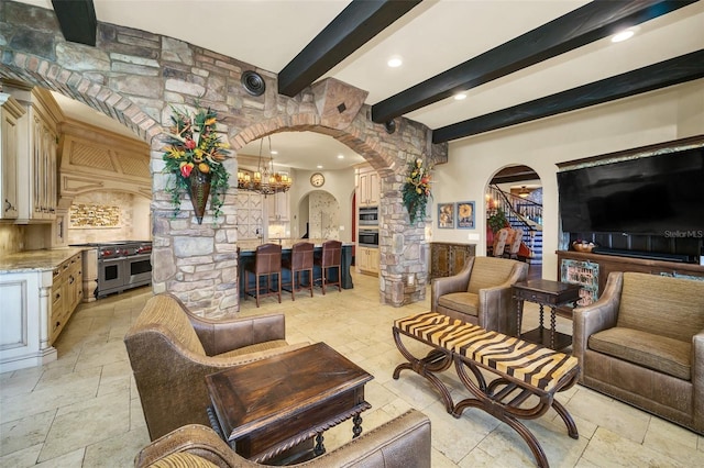 living room with an inviting chandelier and beamed ceiling