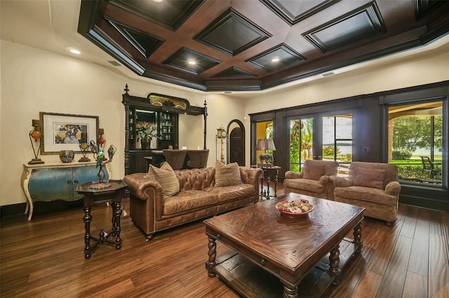 living room featuring beam ceiling, coffered ceiling, dark wood-type flooring, and ornamental molding