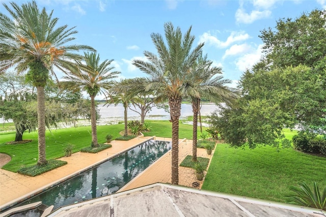 view of home's community with a swimming pool and a yard