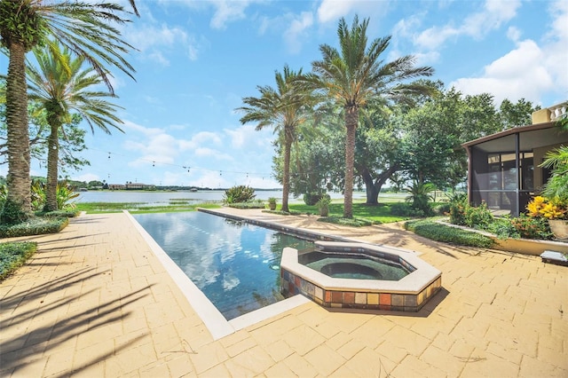 view of pool with a patio, a sunroom, an in ground hot tub, and a water view