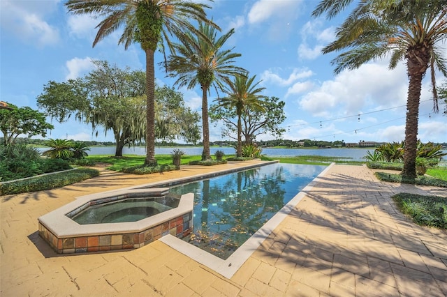 view of swimming pool with a water view and an in ground hot tub