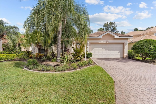 mediterranean / spanish-style home featuring a front yard and a garage