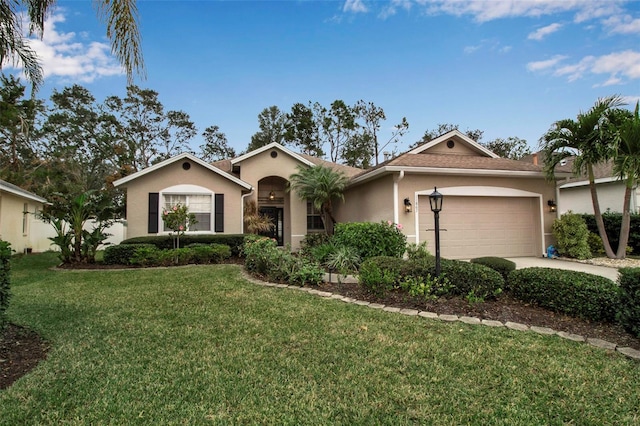 single story home featuring a garage and a front lawn