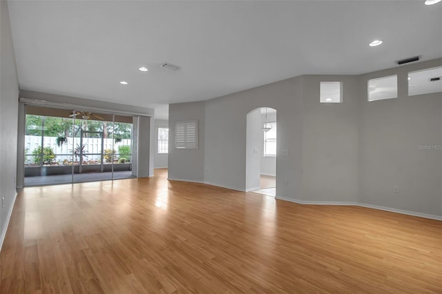 spare room featuring light hardwood / wood-style floors, a wealth of natural light, and ceiling fan