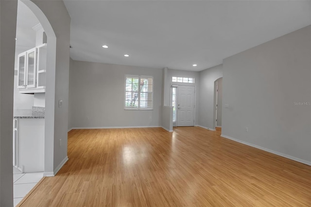 unfurnished living room with light wood-type flooring