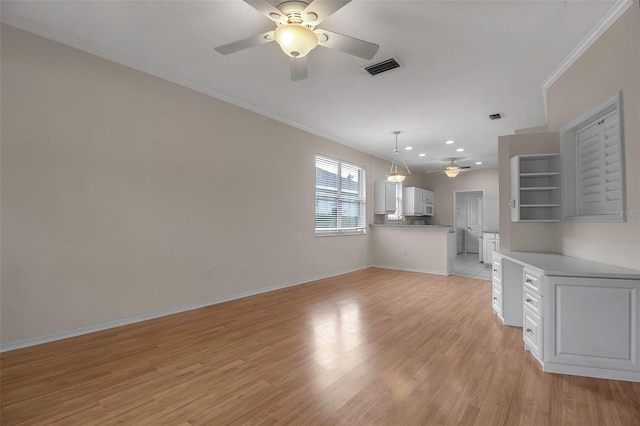 unfurnished living room with crown molding, ceiling fan, and light hardwood / wood-style floors