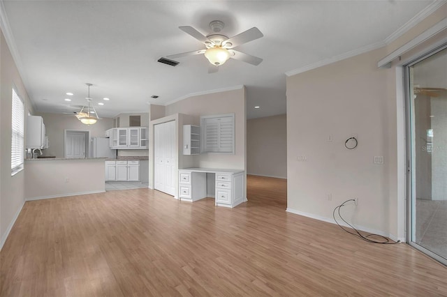 unfurnished living room featuring crown molding and light hardwood / wood-style flooring