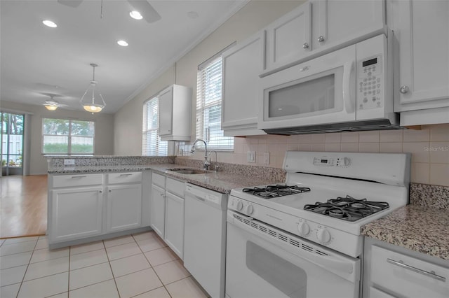 kitchen featuring white cabinets and white appliances