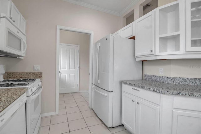 kitchen with white cabinetry, light stone counters, crown molding, white appliances, and light tile patterned floors