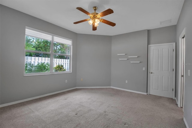 spare room with light carpet and ceiling fan