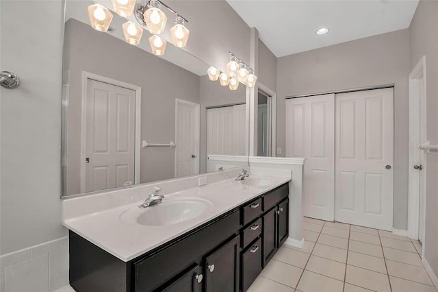 bathroom with tile patterned flooring, vanity, and a chandelier