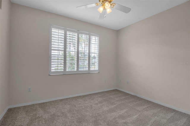 carpeted spare room with ceiling fan