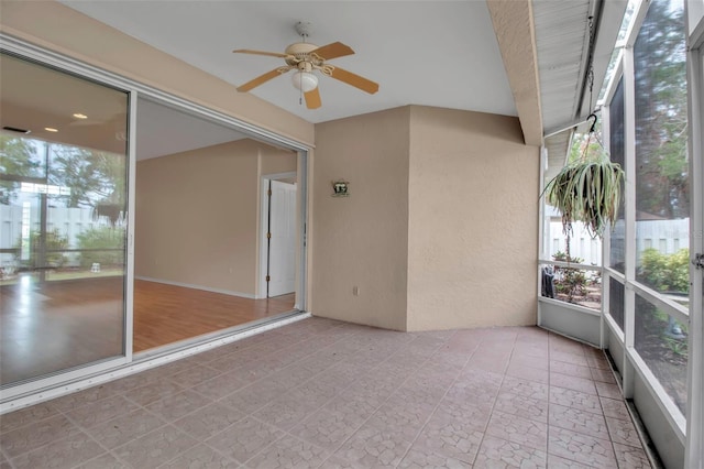 unfurnished sunroom featuring plenty of natural light and ceiling fan