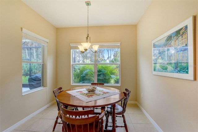 dining space with an inviting chandelier and light tile patterned flooring