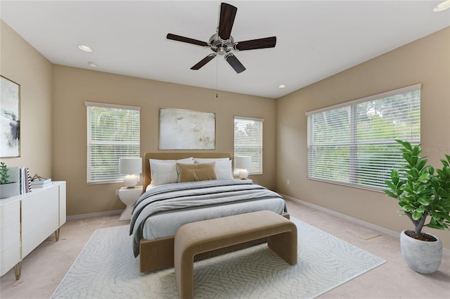 bedroom featuring light carpet and ceiling fan