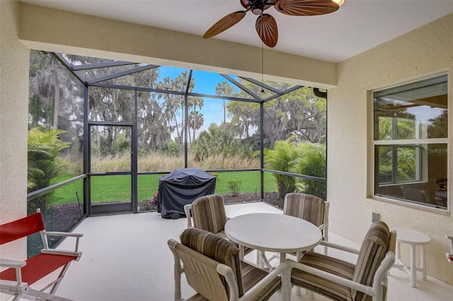 sunroom / solarium featuring ceiling fan and a healthy amount of sunlight