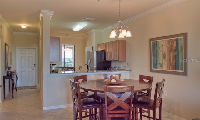 dining room with light tile patterned flooring, ornamental molding, sink, and a chandelier