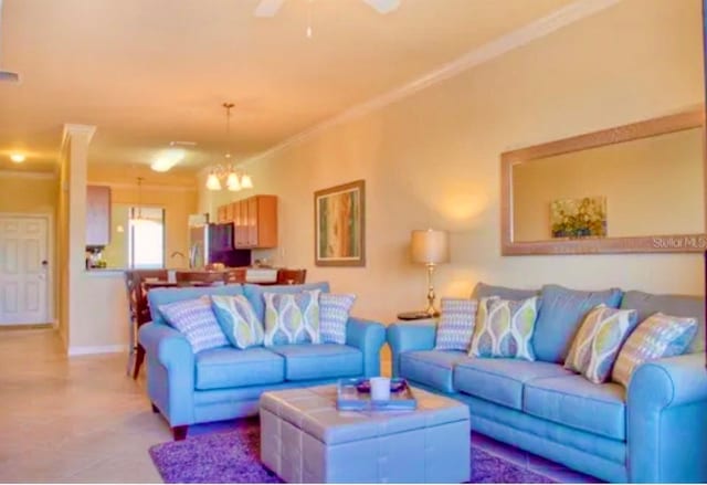 living room featuring ceiling fan with notable chandelier and crown molding