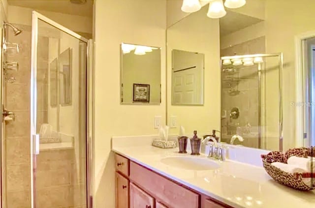 bathroom featuring an enclosed shower and vanity