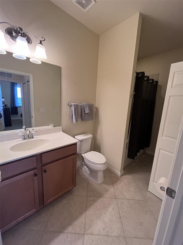 bathroom featuring vanity, toilet, and tile patterned floors