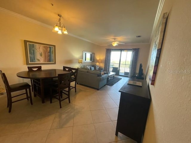 7005 River Hammock Dr Unit 404, Bradenton, FL 34212 - dining space featuring crown molding, a textured wall, ceiling fan with notable chandelier, light tile patterned floors, and visible vents