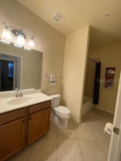 7005 River Hammock Dr Unit 404, Bradenton, FL 34212 - full bath featuring visible vents, tile patterned floors, toilet, and vanity