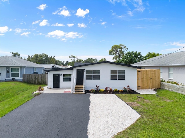 ranch-style home with a front lawn