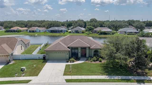 view of front of home featuring a front yard, a garage, and a water view