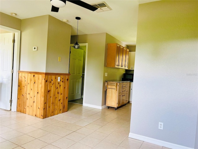 kitchen with ceiling fan, hanging light fixtures, and light tile patterned floors