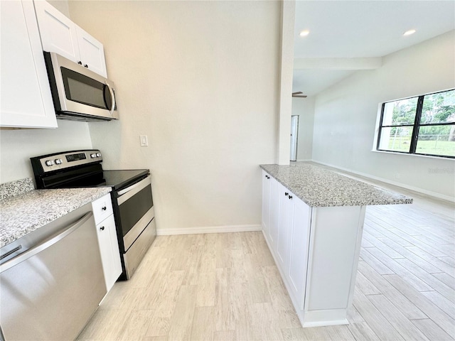 kitchen with white cabinets, appliances with stainless steel finishes, light hardwood / wood-style floors, and kitchen peninsula