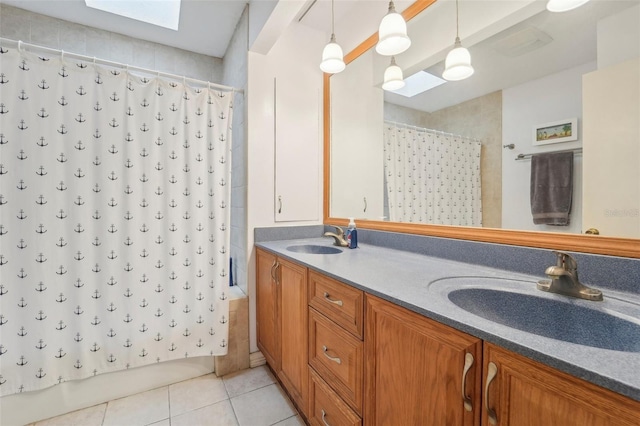 bathroom featuring shower / bathtub combination with curtain, tile patterned floors, a skylight, and vanity