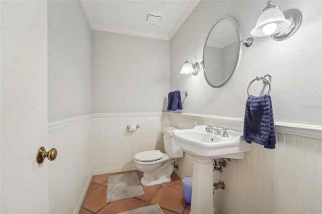 bathroom with crown molding, tile patterned floors, and toilet