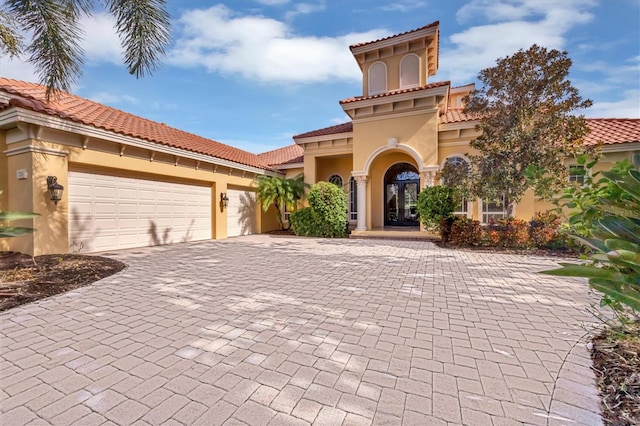 mediterranean / spanish house featuring a garage