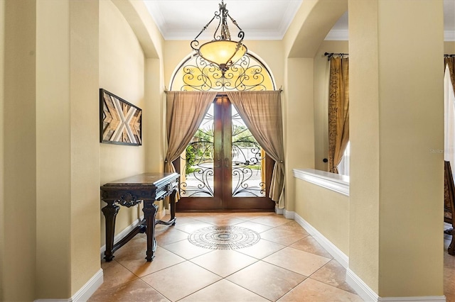 tiled foyer with french doors and crown molding