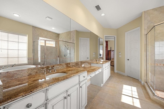 bathroom featuring vanity, a shower with shower door, and tile patterned floors