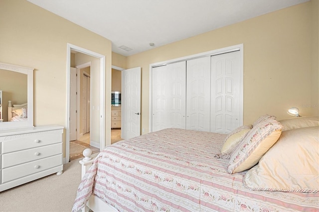 bedroom with light carpet and a closet