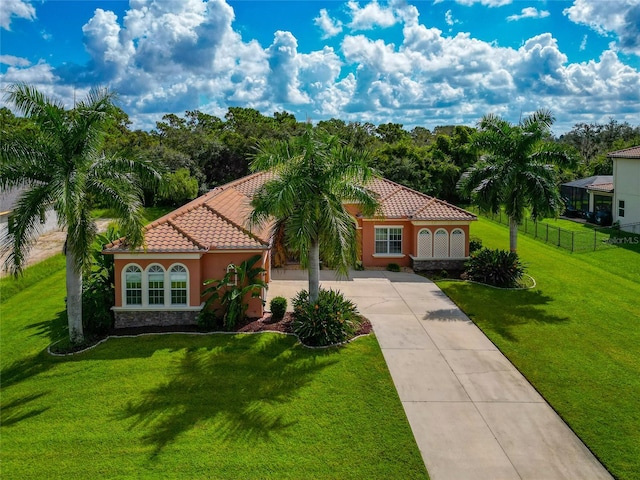 mediterranean / spanish-style house with a front lawn