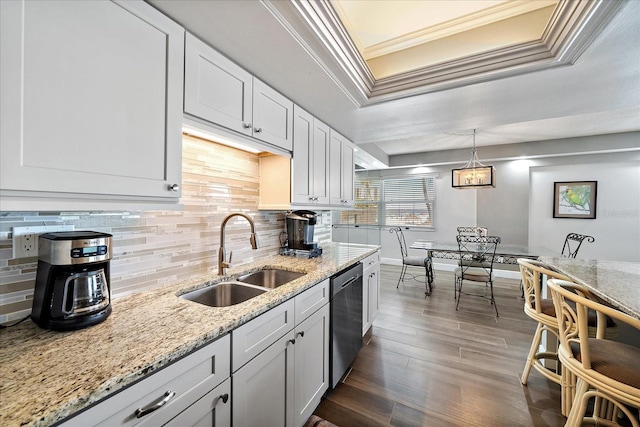 kitchen with dishwasher, dark hardwood / wood-style floors, sink, white cabinetry, and a raised ceiling