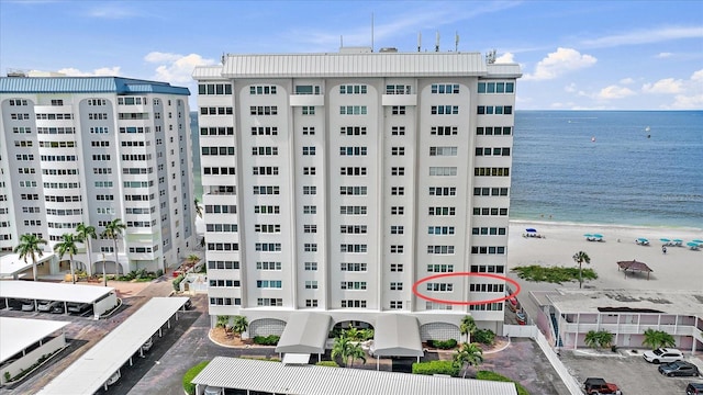 view of property featuring a view of the beach and a water view