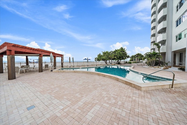 view of pool with a patio and a pergola