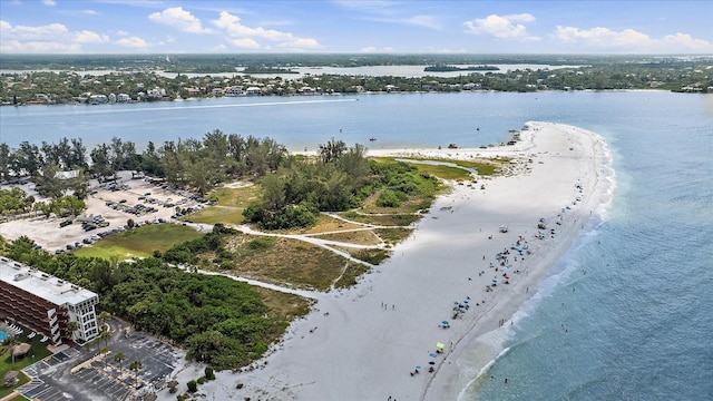 drone / aerial view featuring a water view and a beach view