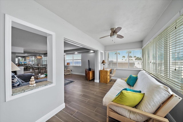 sunroom featuring ceiling fan