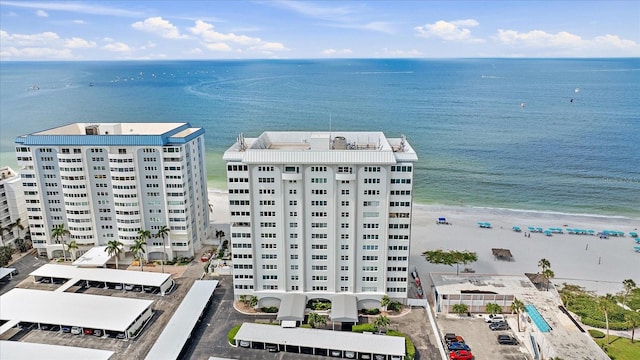 aerial view with a water view and a beach view