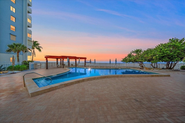 pool at dusk with a pergola