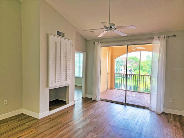 empty room with wood-type flooring, vaulted ceiling, and ceiling fan