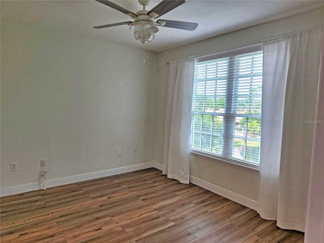 empty room with ceiling fan and hardwood / wood-style floors